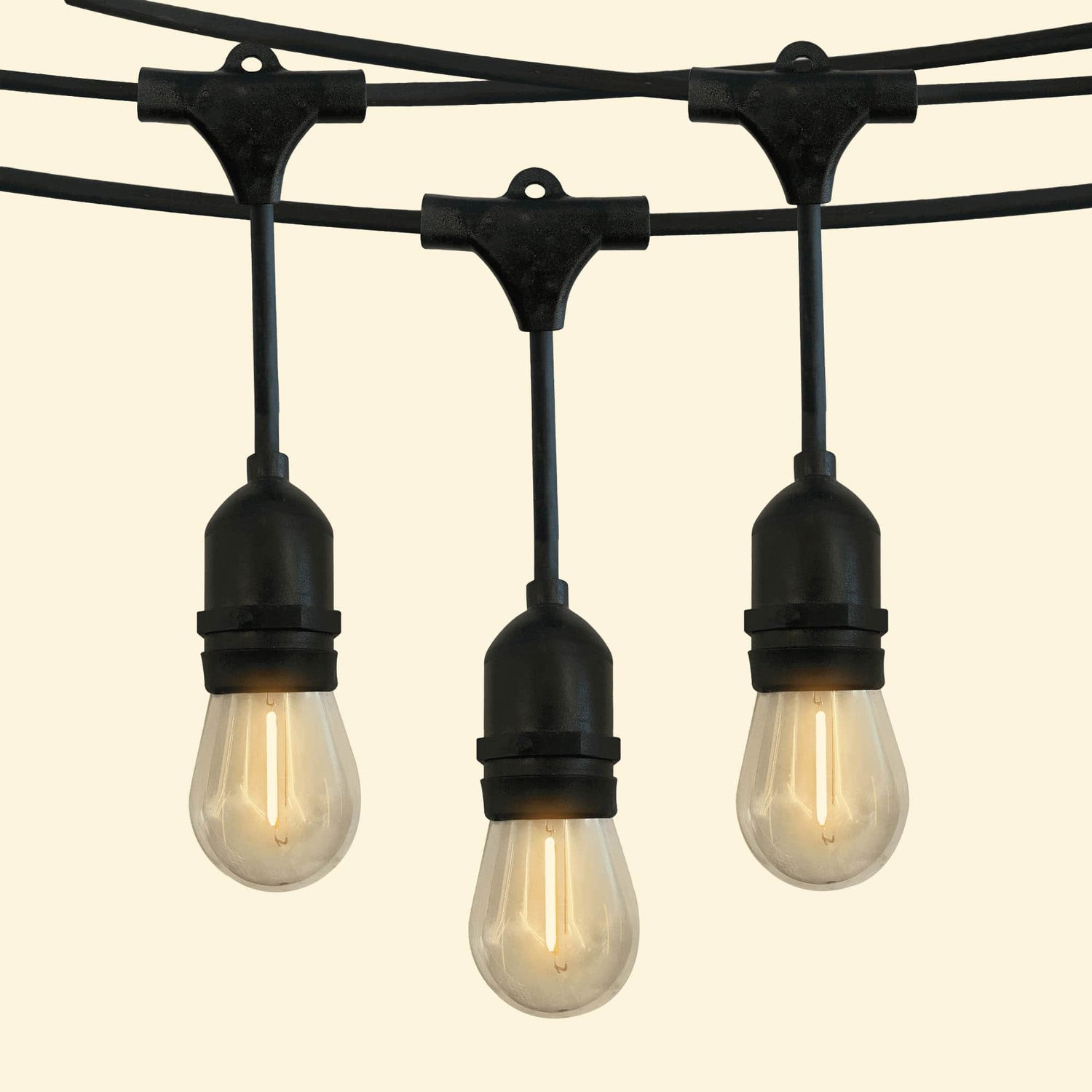 Guirlande lumineuse goutte avec ampoules LED à filament diffusant une lumière chaude, idéale pour une décoration extérieure élégante et conviviale.